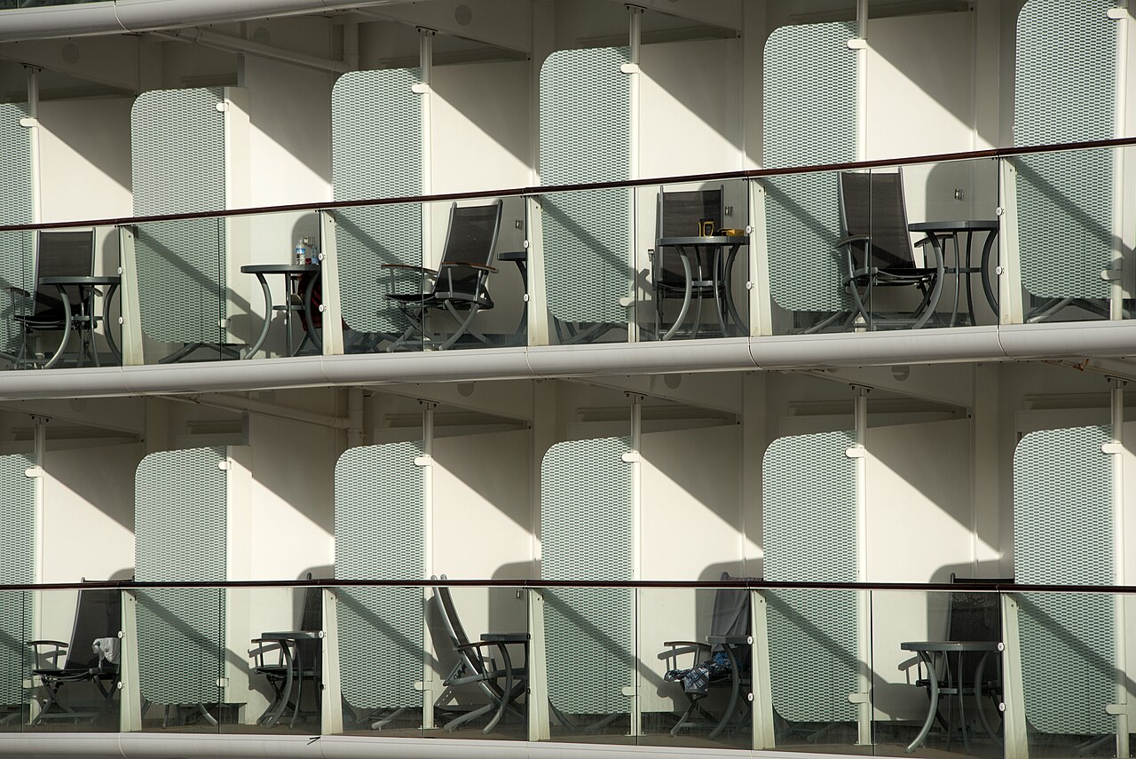 Cruise cabin balconies with outdoor chairs.