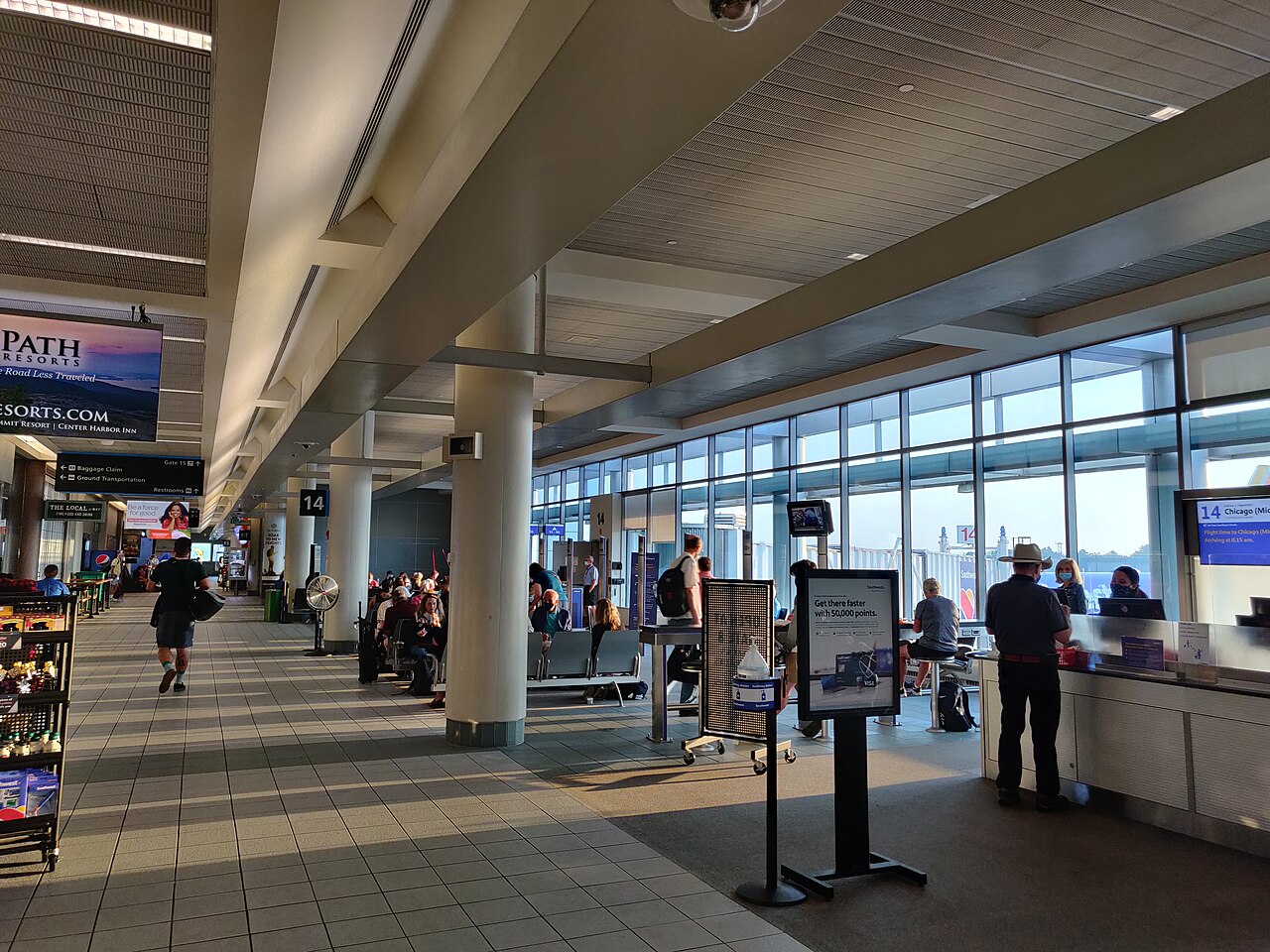 Passengers and gate information in an airport departure area.