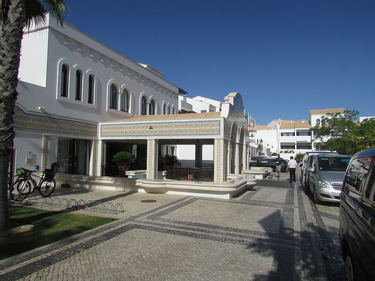 A hotel reception entrance beside an arrival driveway.