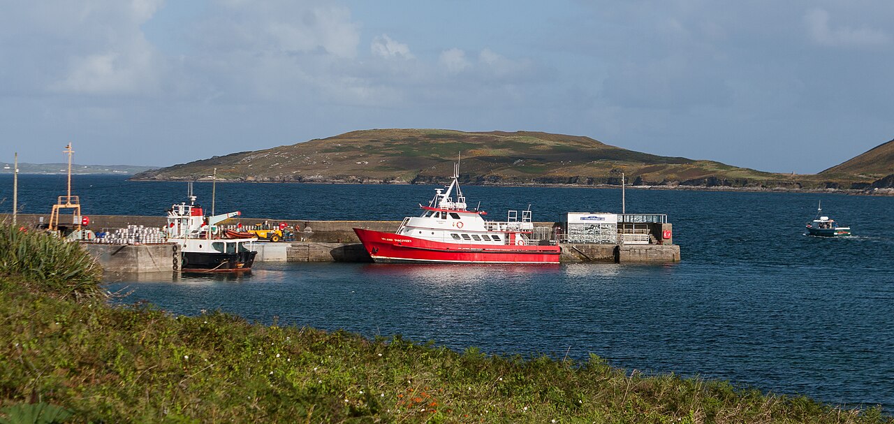 A ferry and smaller boats in a harbour serving island routes.