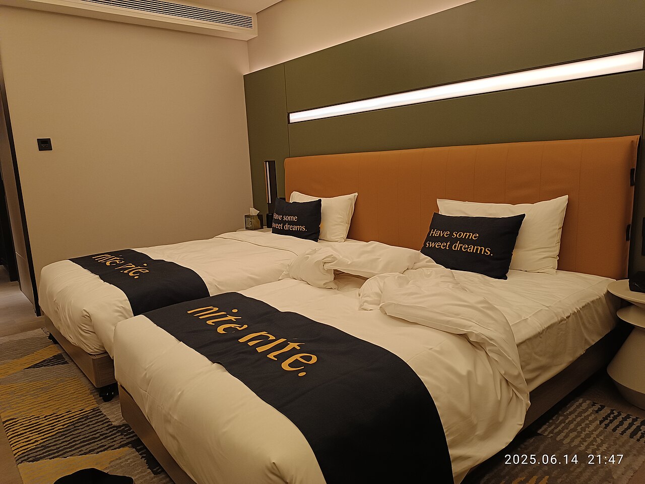 Twin beds in a modern hotel room.