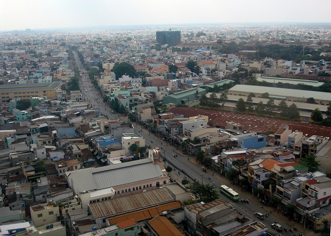 City buildings and streets seen from an aircraft window.