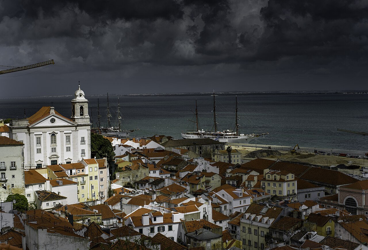 Lisbon rooftops and a church overlooking the river.